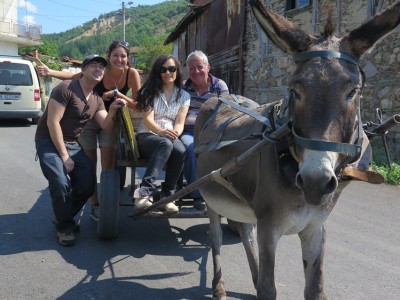 Tourists on a ride in a Bulgarian karutsa with a donkey