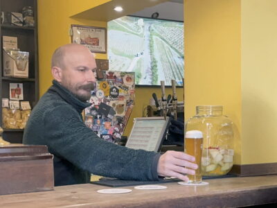 The barman at Bira Bar gives us a cold beer