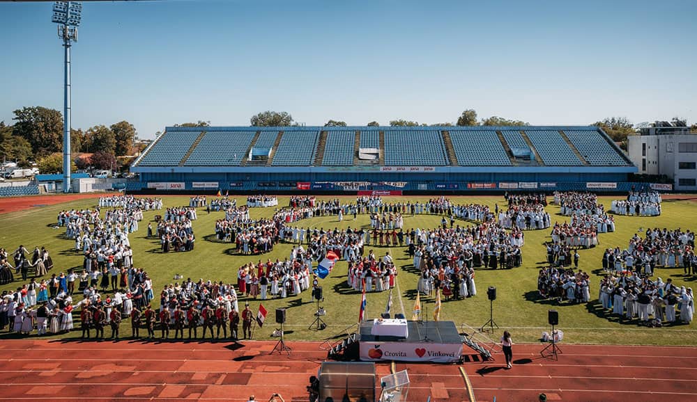 Numerous dance groups dancing at a stadium during the Vinkovci Autumn Festival in Croatia